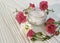 Cosmetic cream, roses, white wooden bright, bottle,