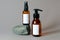 Cosmetic dark amber glass bottles set with blank labels. Natural organic bathroom soap and body spray on stone. Beauty product