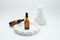 Cosmetic jar of facial essence stands on the podium. Cosmetics on a white background. Mockup Body oil bottle