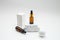 Cosmetic jar of facial essence stands on the podium. Cosmetics on a white background. Mockup Body oil bottle