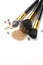 Cosmetic liquid foundation or cream, loose face powder, various brushes for apply makeup. Make up concealer smear and powder