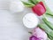 Cosmetic lotion cream moisturizer wellness treatment protection , flower tulip on wooden backgrounorganic d