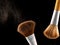 Cosmetic makeup brushes on black background flash explosion splash powder shadow blush.