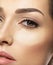 Cosmetic makeup tonal foundation is on woman`s face.