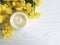 Cosmetic moisturizer cream balm wellness yellow chrysanthemum product flower white wooden