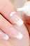 Cosmetic moisturizing cream on female fingernail