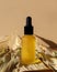Cosmetic oil bottle, black dropper, dry leaves, beige background. Vertical mockup, banner, poster, copy space. Natural organic