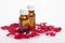 Cosmetic oil in bottles rose in rose petals on a white backgroun