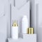 Cosmetic packaging set. White bottles with gold caps. Abstract gray background with podium. Product package mock-up. Template