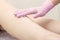 Cosmetic procedure applying cream on legs depilation epilation rubbing cream