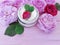 Cosmetic rose bottle cream beautiful on a wooden background product composition