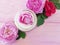 Cosmetic rose bottle cream on a wooden background product composition