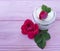 Cosmetic rose cream on a wooden background composition