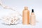 Cosmetic self-care products with natural Dead Sea minerals in wooden bottles against white background with sea corals