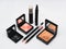 Cosmetic sets with eye shadows and brushes in black plastic cases with mirror