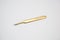 Cosmetic tweezers in gold color on a white background.tools for eyelash extensions and eyebrow design