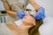 Cosmetician putting protective goggles on female client