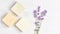 Cosmetics concept panoramic banner. lavender flowers and bars of natural soap on a marble background.