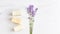 Cosmetics concept panoramic banner. stack of handmade soap, mini lavender bouquet on marble background.