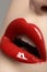 Cosmetics. Fashion bright red lips glossy make-up, clean skin