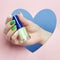 Cosmetics hand makeup, beautiful nails manicure, nail Polish, advertising on colored paper background. Fingers with bright colored