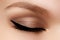 Cosmetics & make-up. Beautiful female eye with black liner