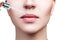 Cosmetics oil applying on plump female lips.