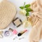 Cosmetics, perfumes, jewelry made of pearls and handbag on a white background.