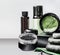 Cosmetics setting ads. Black package template with charcoal powder and green eye patches . Branding mock up. Charcoal cosmetic set