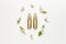 Cosmetics springtime Concept. Cosmetics, spring white flowers green leaves on light background. Cosmetic mock up gold bottles.