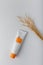 Cosmetics tube mockup template. Cream with sea buckthorn extract, face skin care. Container with no brand orange label on white