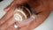 Cosmetological procedure. a snail on the hand in a beauty salon, wound healing close up of snail shell - closeup  treatment by sna