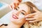 Cosmetologist applaying anti-aging eye gel pads