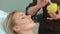 Cosmetologist applies mask on client\'s face