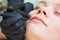 Cosmetologist applying permanent makeup on lips