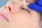 Cosmetologist bending lashes with needle into curlers, lift eyelashes laminaton.