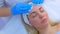 Cosmetologist doctor wiping woman`s face using antibacterial napkins, closeup.