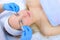 Cosmetologist doctor wiping woman`s face using antibacterial napkins, top view.