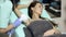 Cosmetologist does laser hair removal of armpits of patient. Epilation procedure