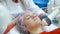 cosmetologist does the procedure Microdermabrasion of the facial skin of woman.