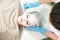 Cosmetologist doing cosmetic face mask treatment