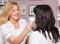 Cosmetologist makes facial massage with electronic device. Cosmetologist in a beauty parlor.