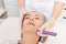 Cosmetologist makes mesotherapy injection for rejuvenation woman face, procedure in beauty salon