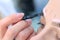 Cosmetologist is tinting woman eyebrows with paint in beauty clinic, closeup.