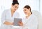 Cosmetologist and woman using tablet in clinic