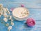 cosmetology cream cosmetic gypsophila rose flower on wooden background