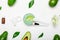 Cosmetology set for cooking, applying face mask. Avocados, leaves, avocado face mask, spatula, brush, measuring spoons, essential