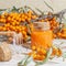 Cosmetology, traditional alternative medicine, herbal medicine, natural sea buckthorn vegetable oil in a glass jar on a table