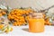 Cosmetology, traditional alternative medicine, herbal medicine, natural sea buckthorn vegetable oil in a glass jar on a table