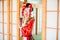 Cosplay. beautiful, modest geisha in a red kimono